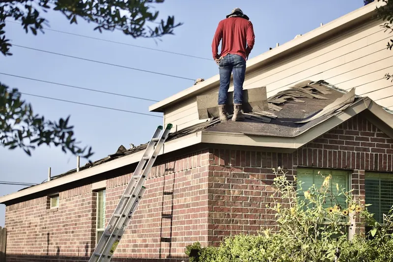 Professional roofer working on a residential roof in Bonadelle Ranchos